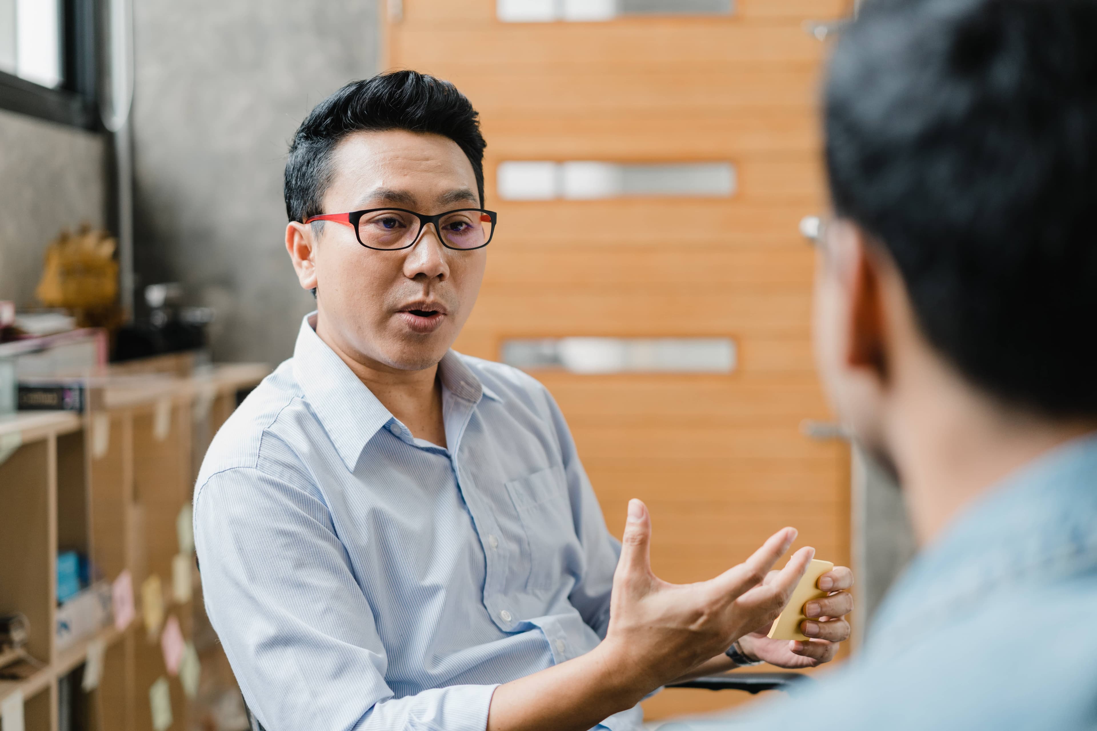 Two people chatting in relaxed office environment